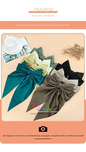 Detailed close-up of large satin bow hair clips in assorted Morandi colors and silk texture