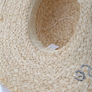 Lafite straw sun hat for women featuring wide brim with letter embroidery for beach vacation