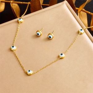 Minimalist evil eye jewelry set with gold necklace and matching stud earrings for women
