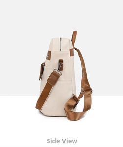 Side view of large PU leather backpack showing cream texture and brown strap details