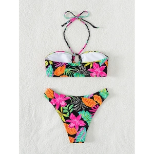 Floral print bikini set with halter top and high cut bottoms on beach towel background