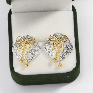 French style geometric square earrings with gold bow and tassel in a green velvet box