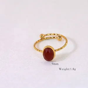 Detail of adjustable ring featuring 9mm red gemstone and handmade hammered texture