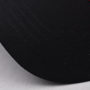 Detailed close-up of parallel stitching on a black cotton canvas baseball cap brim
