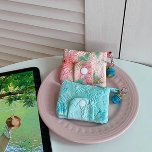 Detail of floral bubble fabric coin purses with snap closure and Friend pendant charm