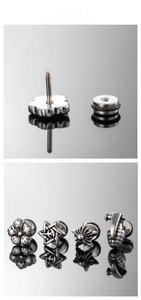 Detail of punk stainless steel earrings featuring flower, star, and grenade designs