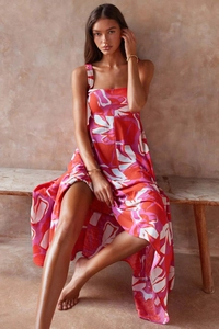 Detailed close-up of the red and pink floral print fabric on the summer maxi dress