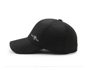 Side view of black baseball cap featuring subtle dark grid texture and white sport logo