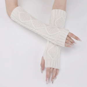 Close-up of white knitted fingerless gloves with diamond cable pattern and arm warmers