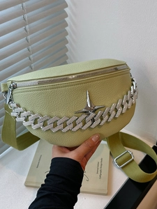 Detail of fruit green lychee leather bag with silver stars and rhinestone chain strap