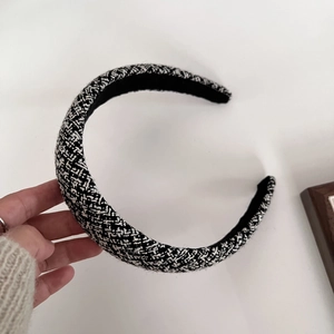 Detail of classic black and white tweed sponge headband with woven texture and thick design