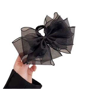 Elegant large black mesh lace bow hair claw clip for bun hairstyles on white background