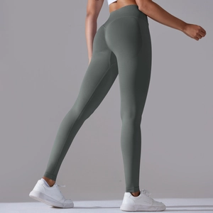 Detail view of forest green high waist seamless leggings with peach lift effect for yoga