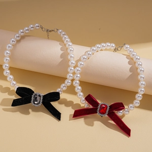 Elegant pearl necklaces with black and burgundy velvet bows and crystal centers