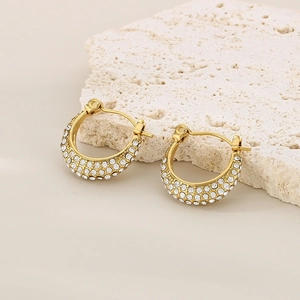 Detail view of U-shaped gold-plated stainless steel hoop earrings with pave-set zircons