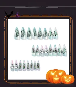 Detail of Halloween press-on nails featuring eye, brain and Bite Me letter patterns