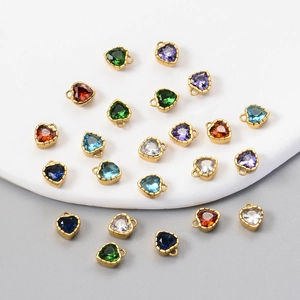 Macro detail of heart-shaped zircon pendants with 18k gold plated stainless steel edges