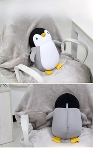 Detail of penguin plush toy showing soft cotton fabric and back zipper for washing
