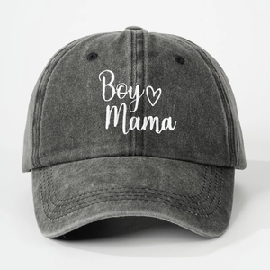Detail of white Boy Mama embroidery on washed charcoal denim baseball cap texture