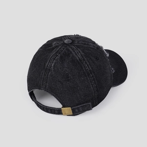 Close-up of distressed black denim baseball cap showing retro texture and metal buckle