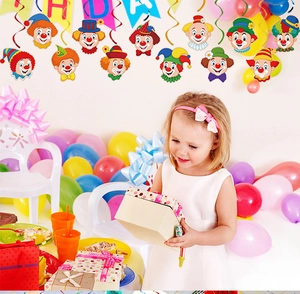 Girl holding gifts with colorful clown spiral ceiling decorations and festive party balloons
