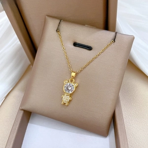 Macro detail of gold teddy bear pendant with brilliant cut crystals and pavé body