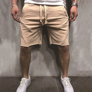 Men's khaki knit fitness shorts with drawstring waist and raw hem finish details