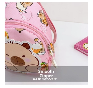 Close-up of smooth silver zipper and stitching on pink cartoon kid's crossbody bag