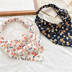 Close-up of floral print elastic headbands in black and white with vintage flower patterns