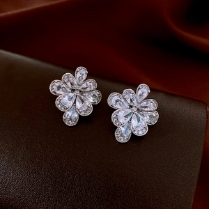 Detailed close-up of sparkling flower earrings with pear-cut cubic zirconia in silver