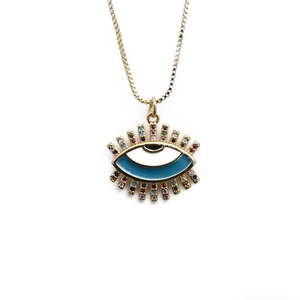 Detail of gold evil eye pendant with blue enamel and colorful cubic zirconia stones