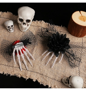Detail of Halloween skull hand hair clips with red and black flowers on mesh lace