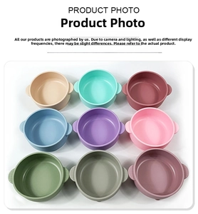 Detailed view of colorful baby silicone suction bowls with dual handles in various shades.