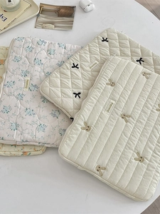 Quilted laptop sleeve with cute rabbit embroidery and bow detail in various patterns