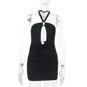 Detail of the black halter dress featuring chic cutout and pleated texture on fabric