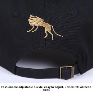 Close-up of black baseball cap rear with gold lion embroidery and metal adjustment buckle