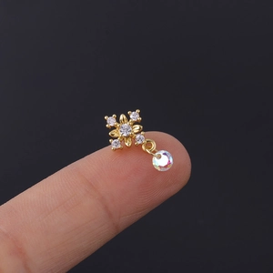 Detail of a mini gold floral earring with clear zircons and iridescent crystal drop