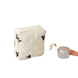 Quilted off-white sanitary napkin storage bag with black rabbit embroidery and zipper