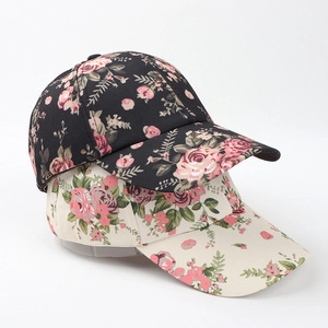 Floral print baseball caps in black and cream featuring minimalist ethnic flower patterns