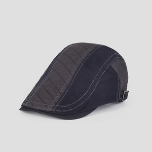 Close-up of vintage cotton flat cap showing contrast stitching and diamond quilted texture