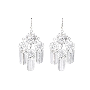 Vintage bohemian silver earrings with hollow flower patterns and long flat tassels