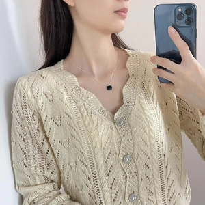 Close-up of minimalist 925 silver necklace with black zircon square pendant on model