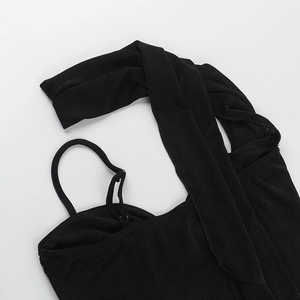 Detail of adjustable straps and fine knit texture on a black sexy crop top for women