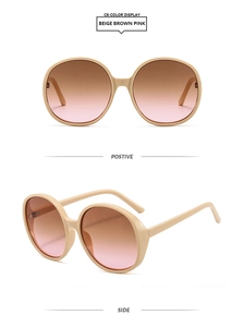 Detail view showing beige oversized round sunglasses with brown pink gradient lenses