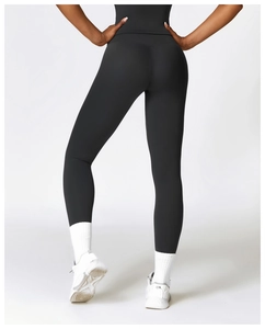 Detail view of high waisted black yoga pants showing butt lifting fit and peach hip curve