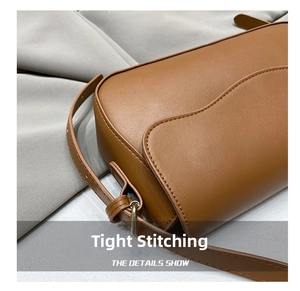 Detail showing high-quality stitching on the brown lychee pattern leather shoulder bag