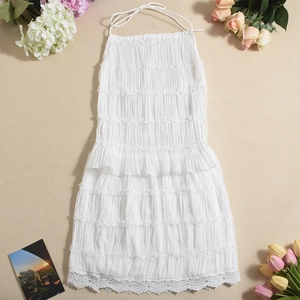 Detail shot of white halter neck top with pleated texture and delicate lace hem edges