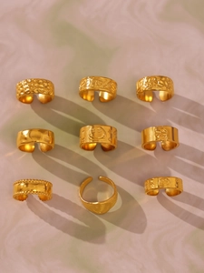 Set of nine assorted gold-plated stackable rings with vintage textures and patterns