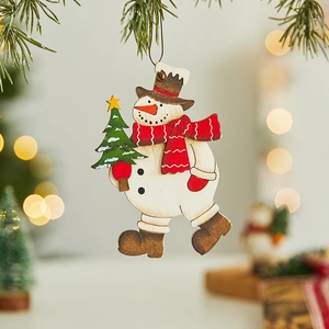 Detailed view of hand-painted wooden snowman ornament hanging on a festive Christmas tree