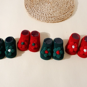 Non-slip baby knit socks with 3D floral accents in red and dark green festive colors